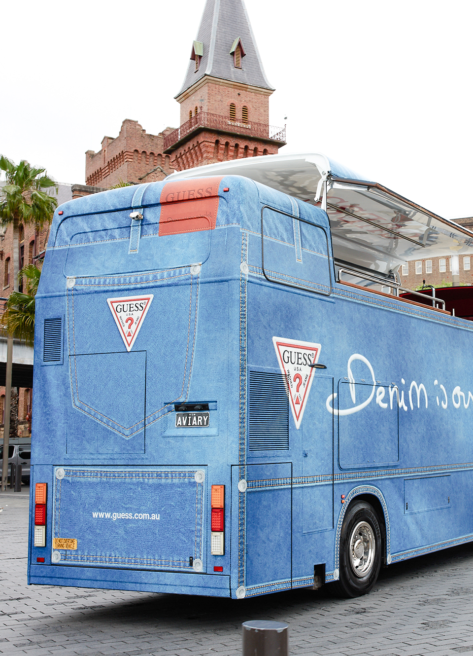 A double-decker GUESS bus designed to look like denim fabric.
