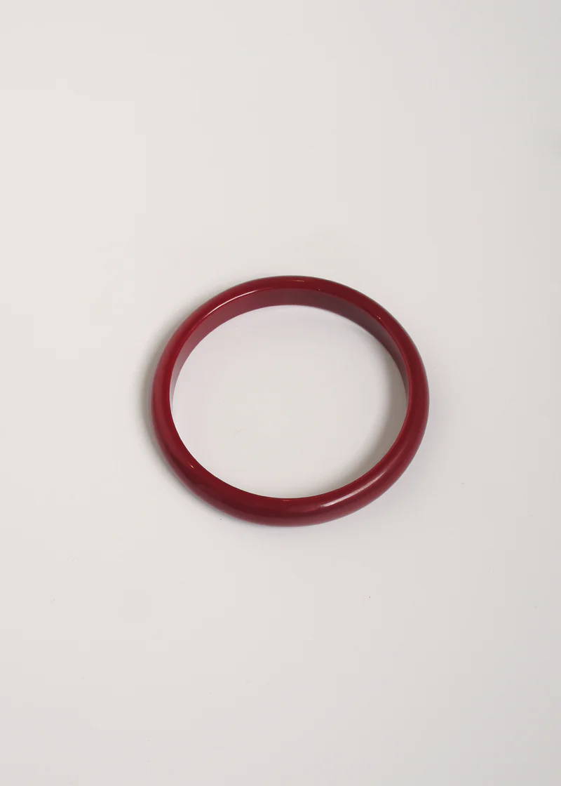 A simple burgandy red circular bangle