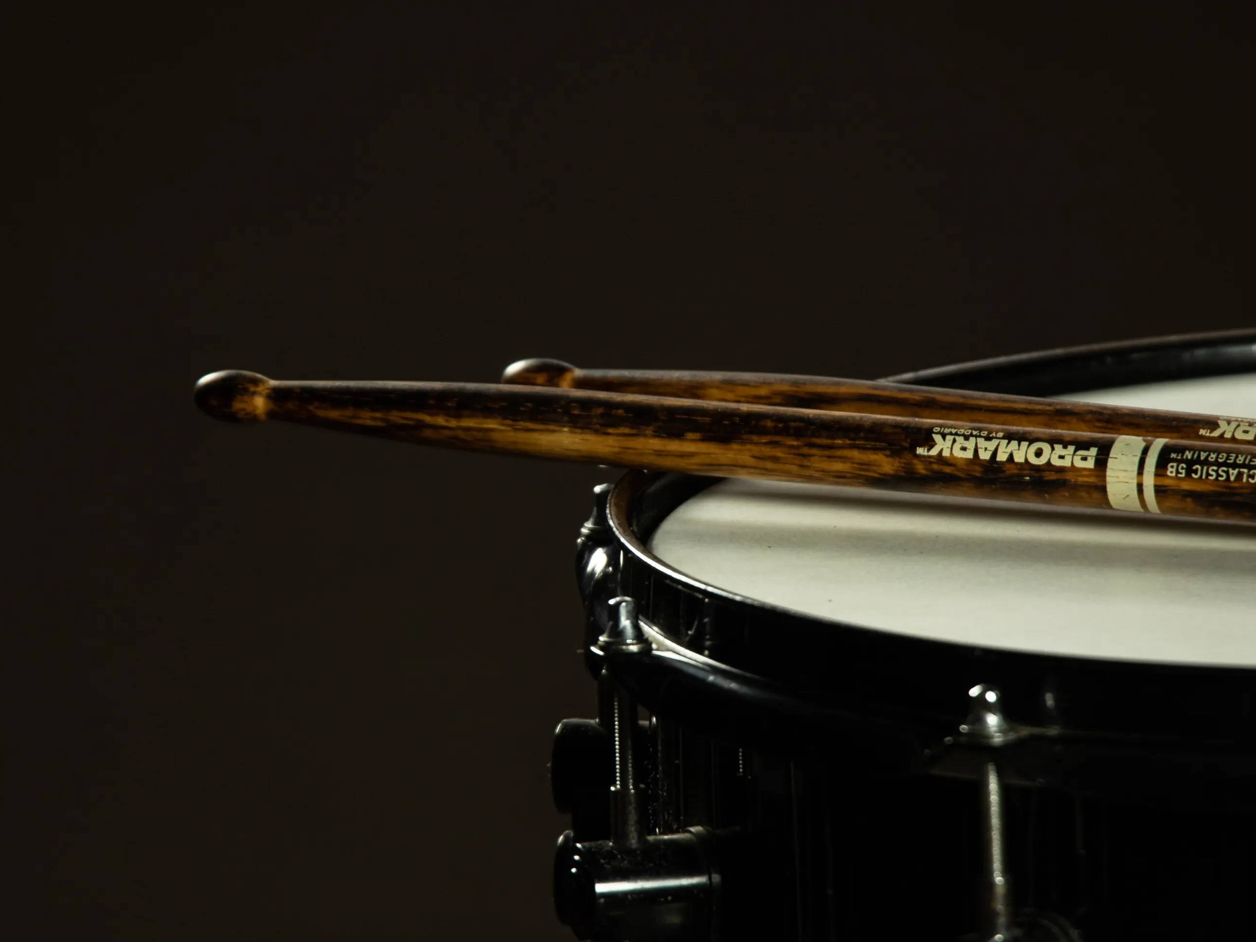 Drumsticks resting on a snare drum