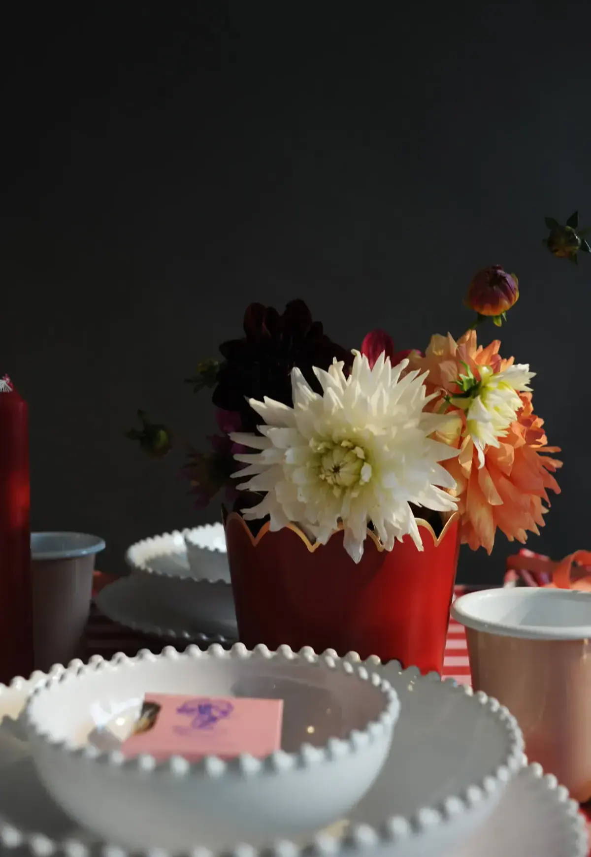 A close up image of some dahlias in the Tooka Red Scallop Planter.