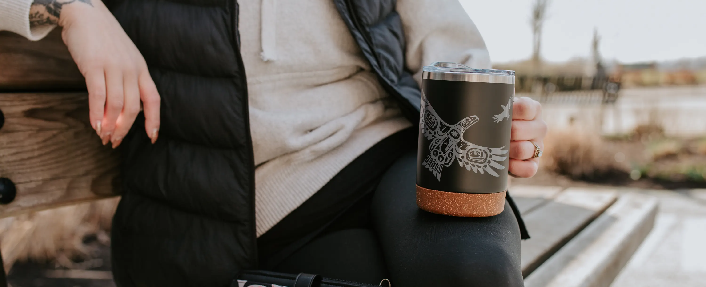 Cork Base Travel Mugs featuring Indigenous artwork — woman holding mug outdoors — Native Northwest