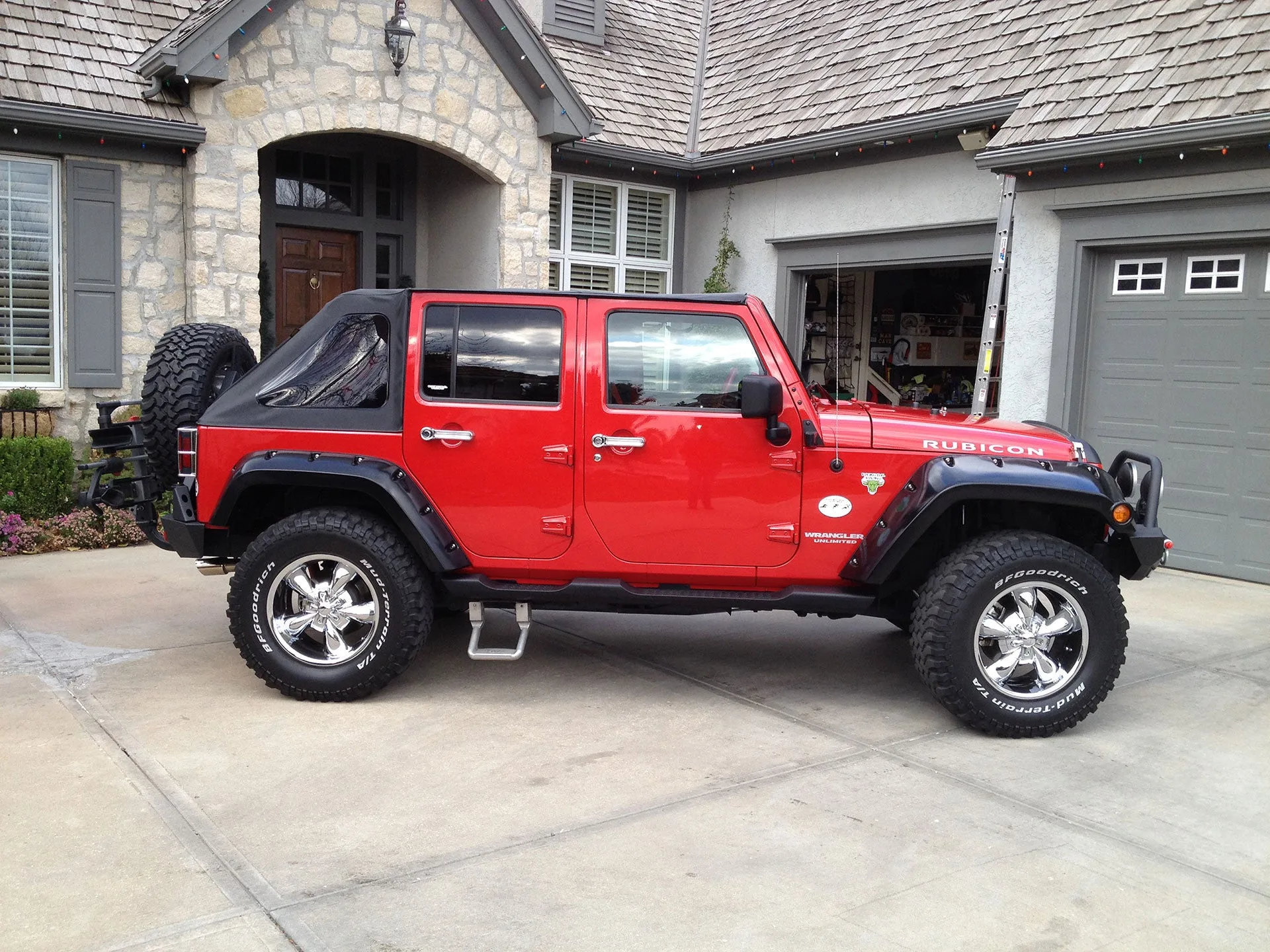 Front-three-quarter John and Laurie 2010 Jeep Wrangler JK seven-slot grille round headlights exterior Conductor's Special 228H train horn featured install photo 1