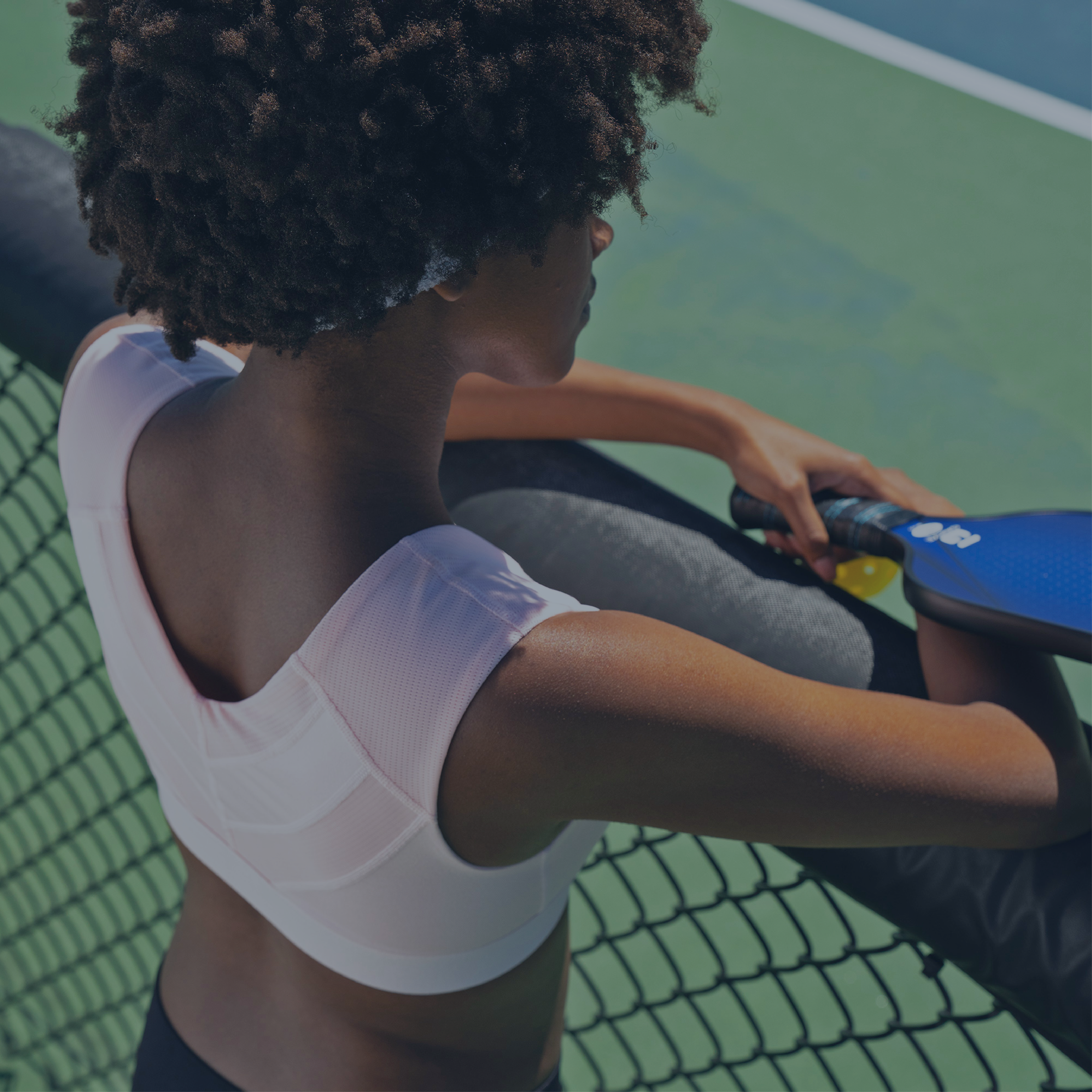 Woman in Shoulder Support Bra playing pickleball