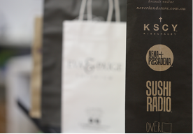 Shopping bags with logos for various brands.