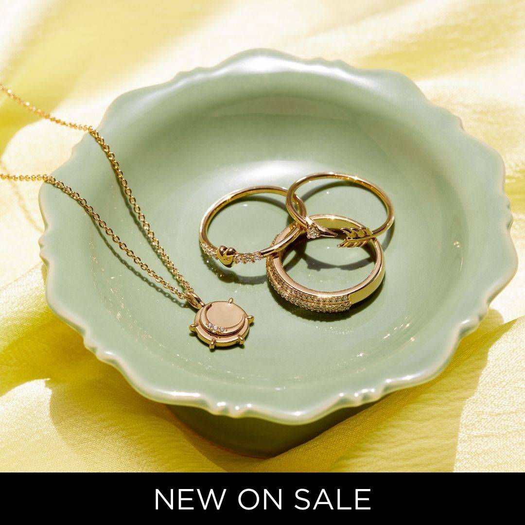 SHOP NEW ON SALE. (IMAGE DESCRIPTION OF A NECKLACE AND RINGS ON A JEWELRY TRAY)