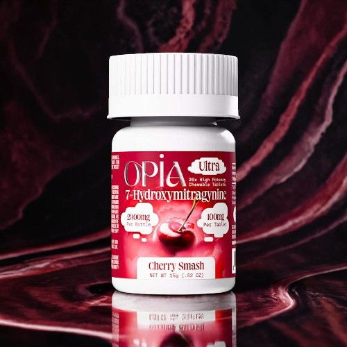 Bottle of Opia dietary supplement with cherry flavor on a dark background.