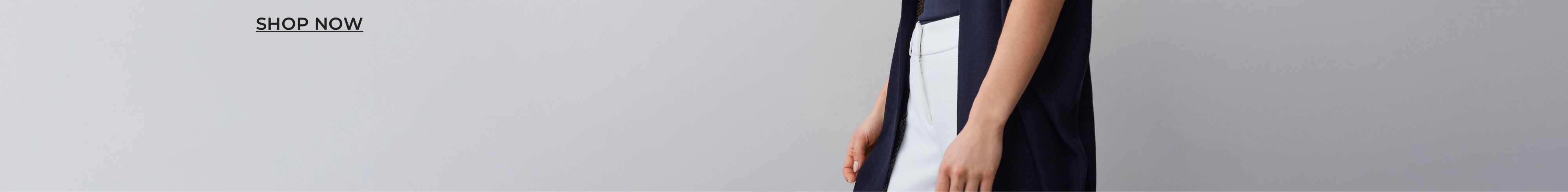 Person holding a white object against a plain background.