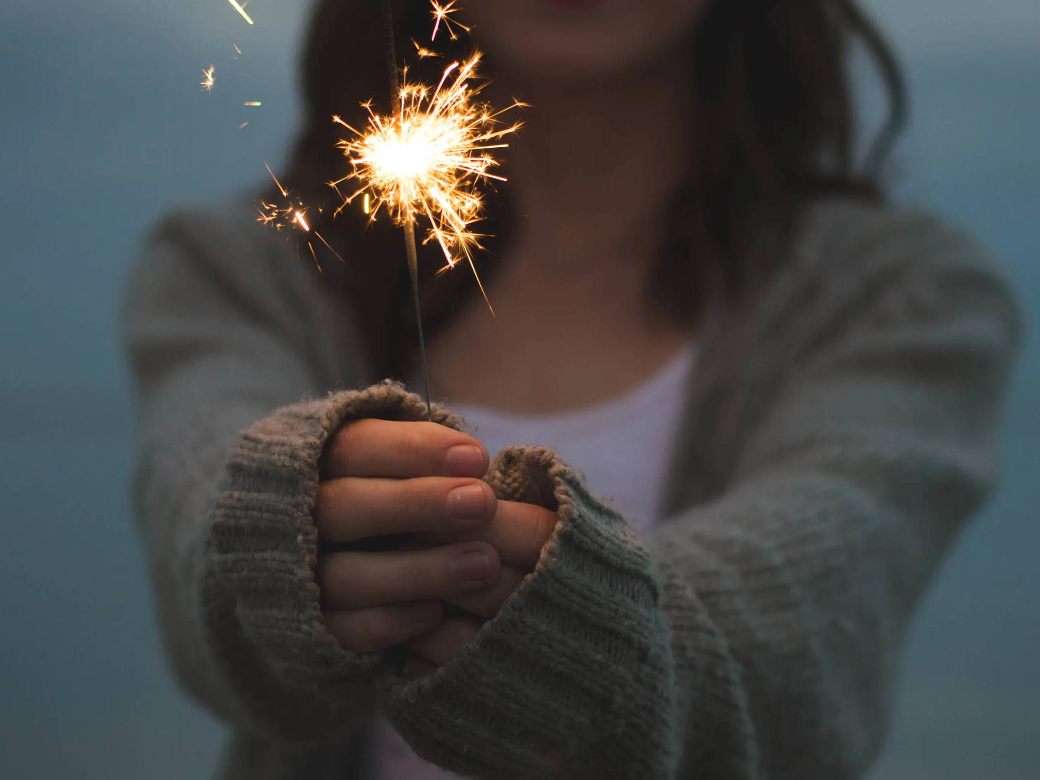 Returns policy showing picture of girl holding a sparkling stick