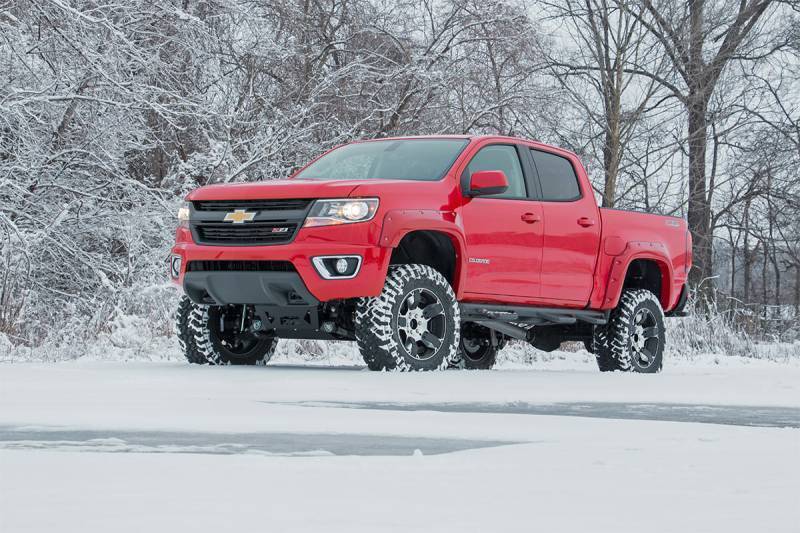 Red Lifted Chevy Truck in Snow