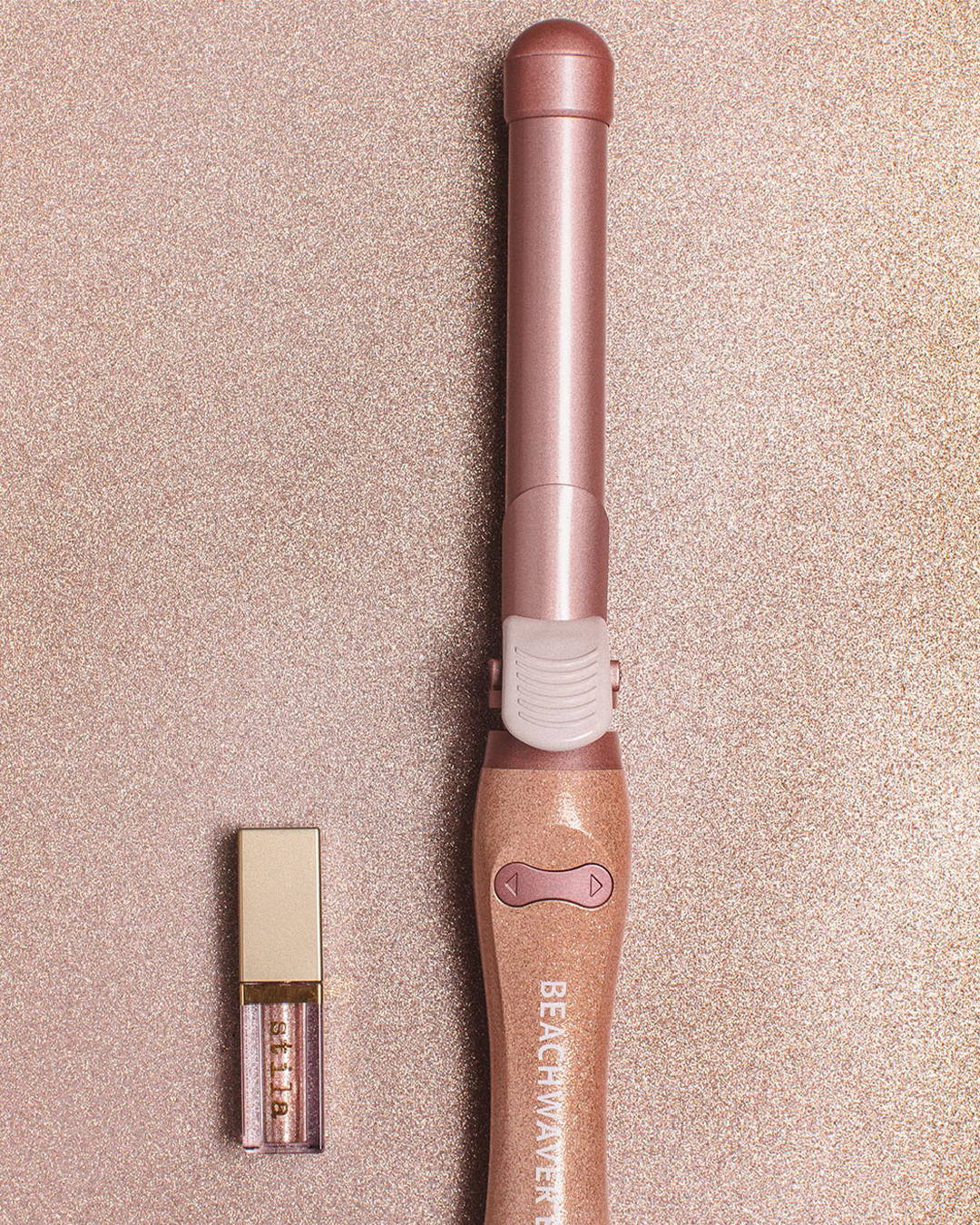 Image of pink b1 Beachwaver hair curler and Stila Glitter Makeup on a pink glitter Background 