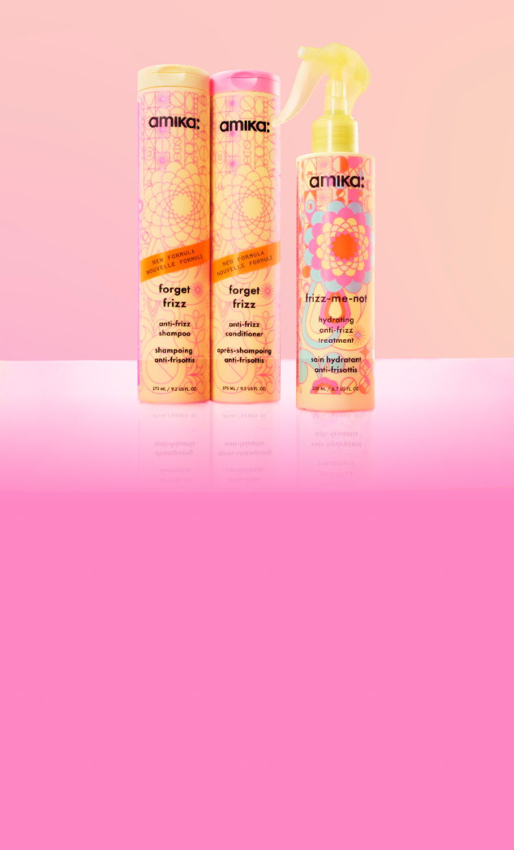 Three hair care products displayed against a pink background.