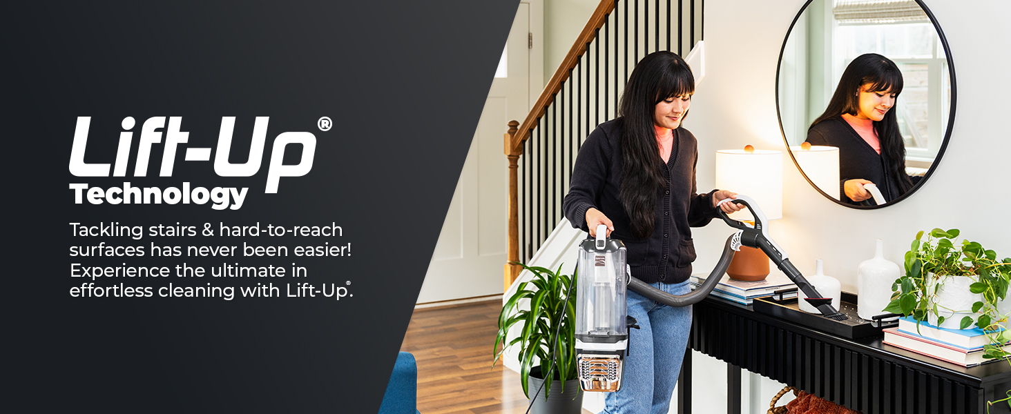 Woman vacuuming with Lift-Up Technology in a stylish home setting.
