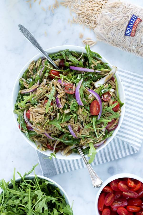 Orzo arugula salad with red onions and grape tomatoes