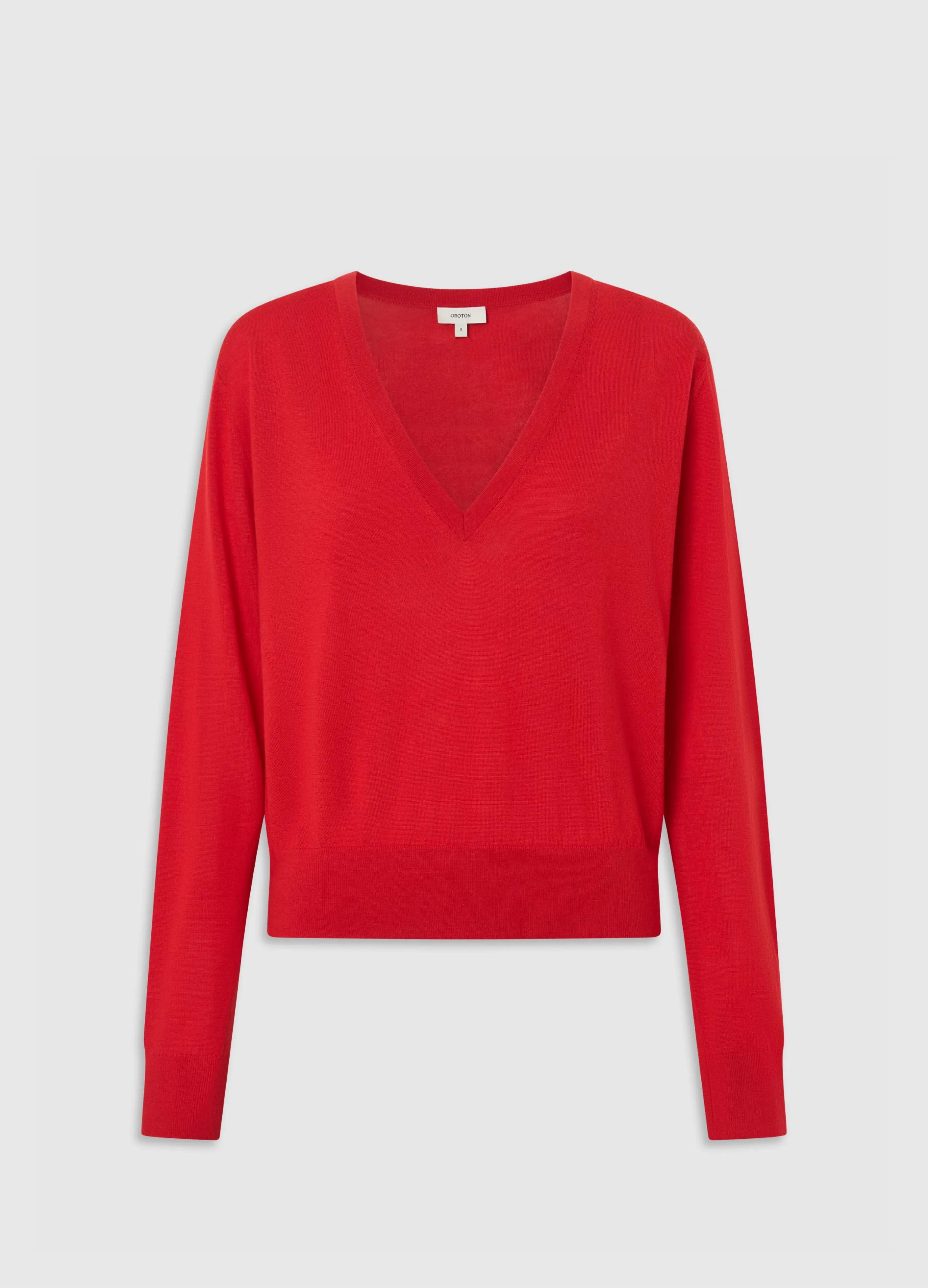 Red v-neck sweater with long sleeves.