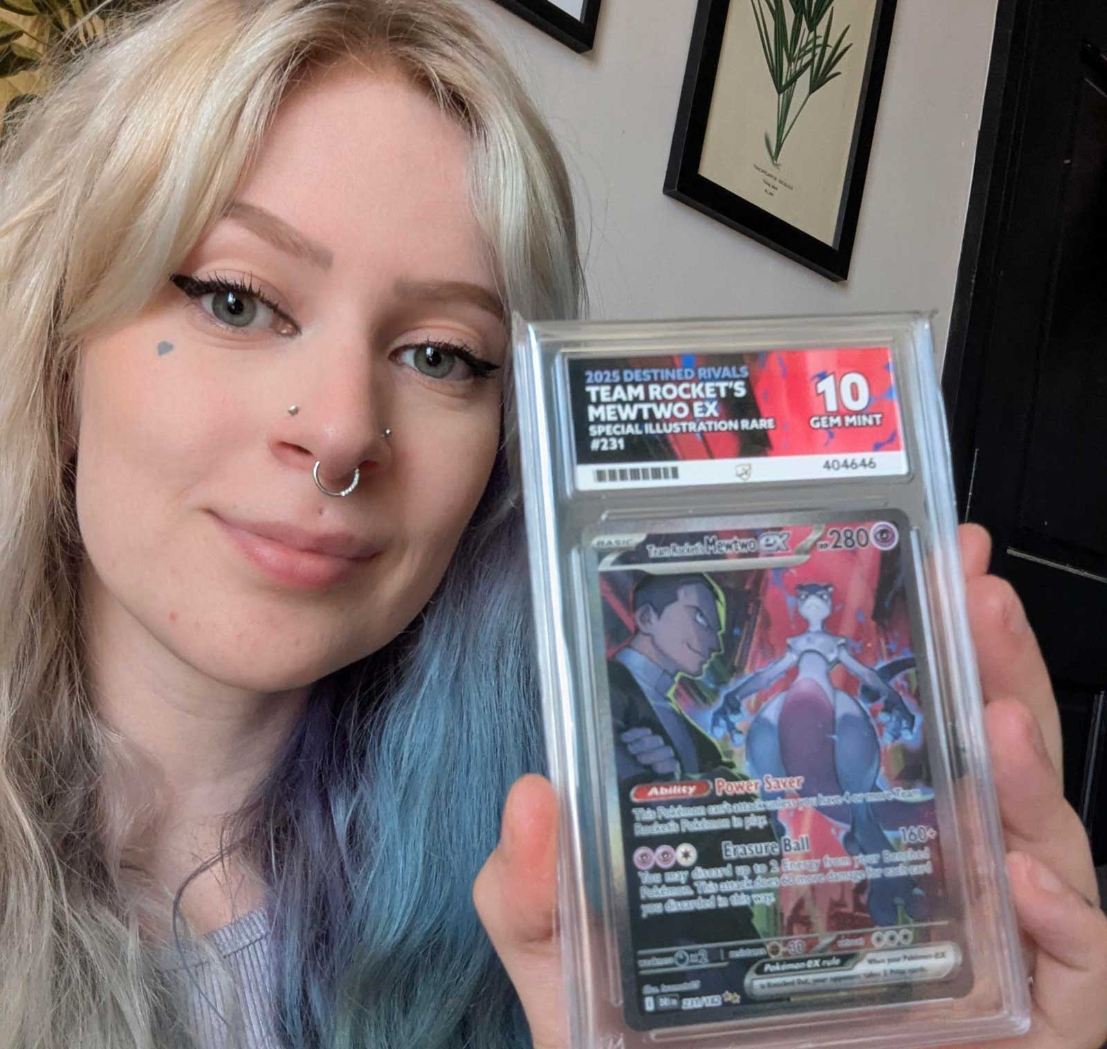 Person holding a graded trading card with colorful artwork.