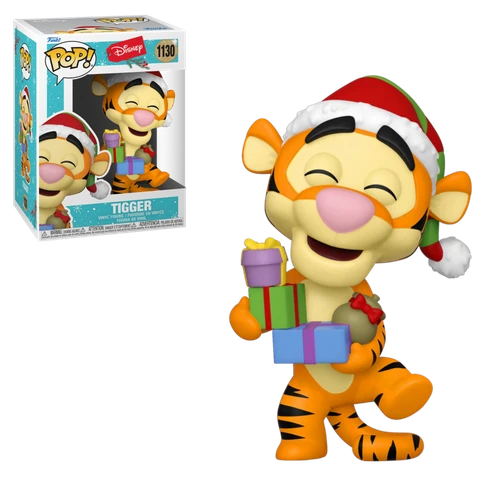 Tigger in a Santa hat holding presents, with a box beside him.
