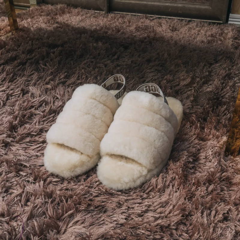 cream ugg slippers on carpet