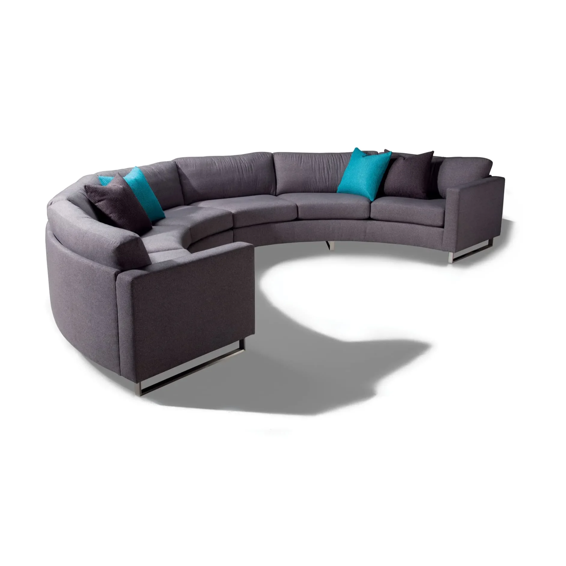 Rounded dary grey couch with blue and black throw pillows