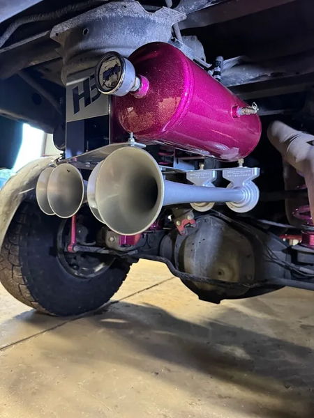 HornBlasters train horn kit with metallic pink air tank and four silver trumpets mounted under truck