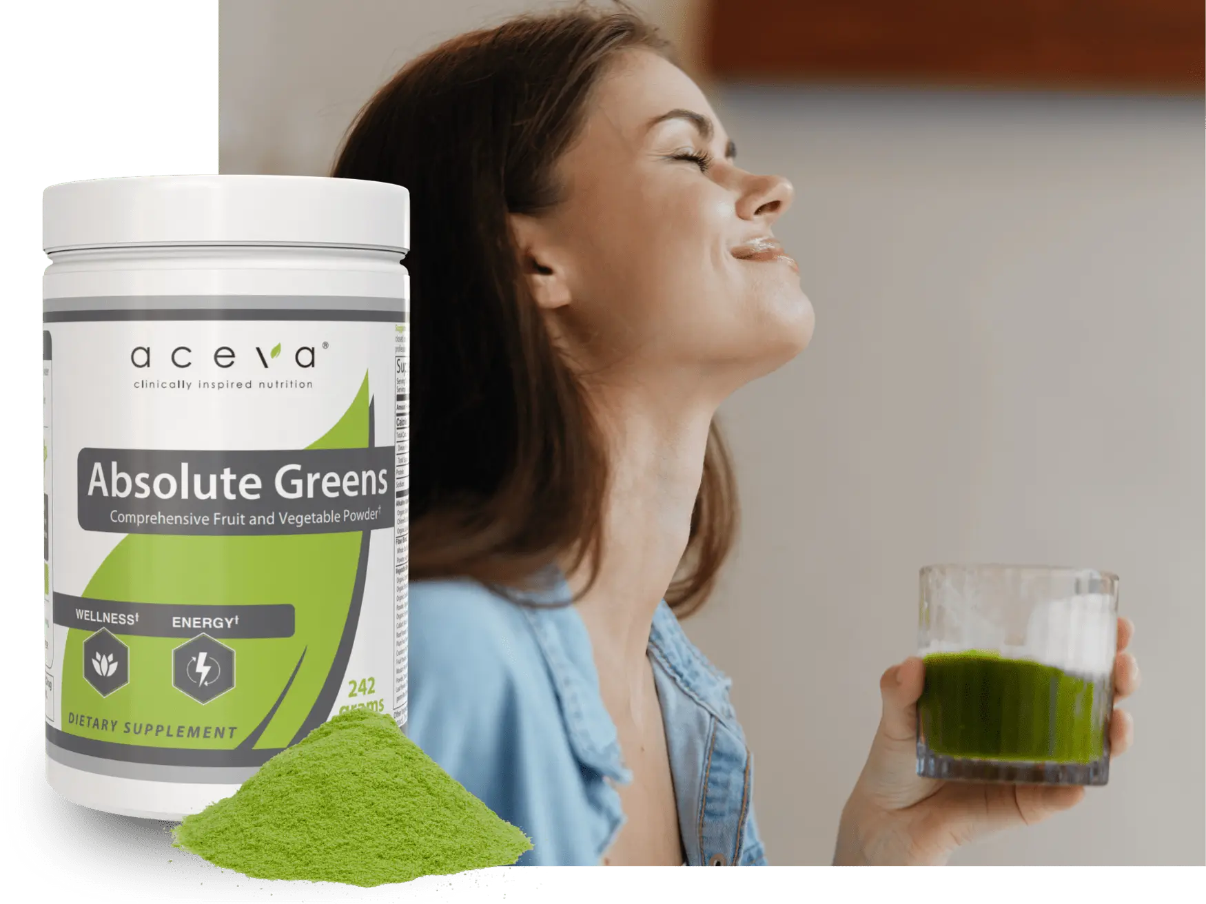woman holding a glass of absolute greens