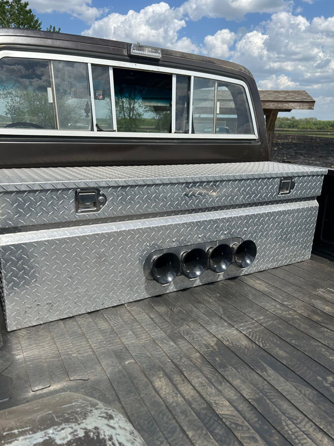 Truck bed view four black train horn trumpets mounted on silver diamond-plate toolbox against cab Kyle's 1985 Chevy K20 Deluxe Pickup Conductor's Special 127H Train Horn Kit gallery photo 2