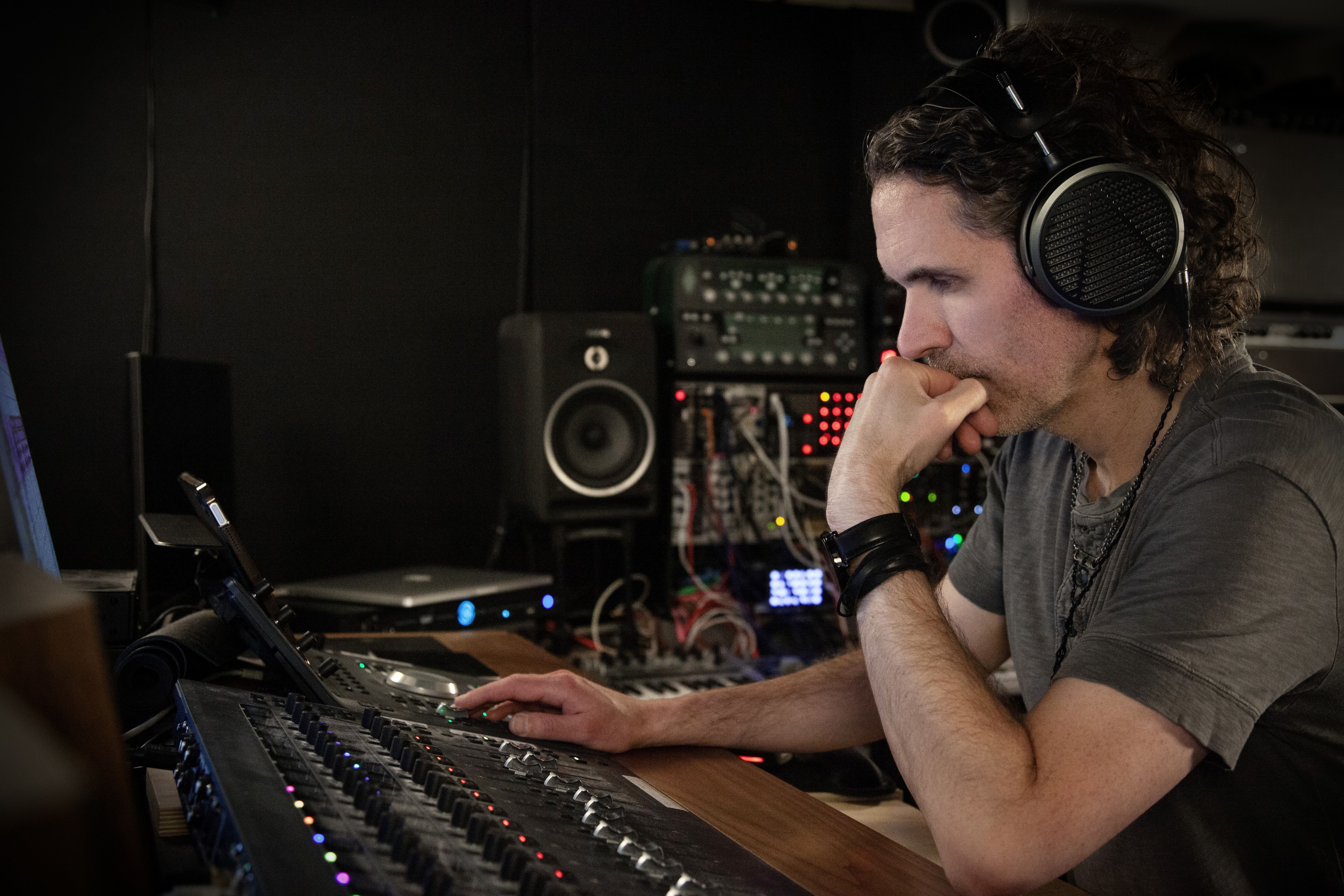 Ryan McCambridge wearing Audeze MM-500 headphones mixing in the studio