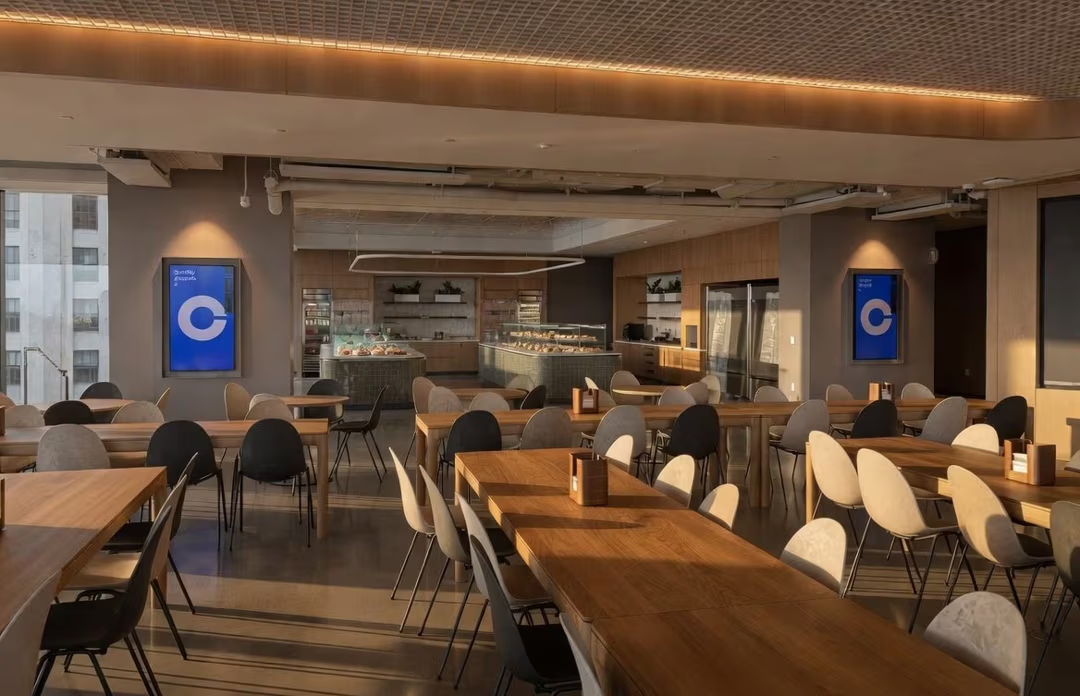Modern restaurant interior with wooden tables and contemporary decor.