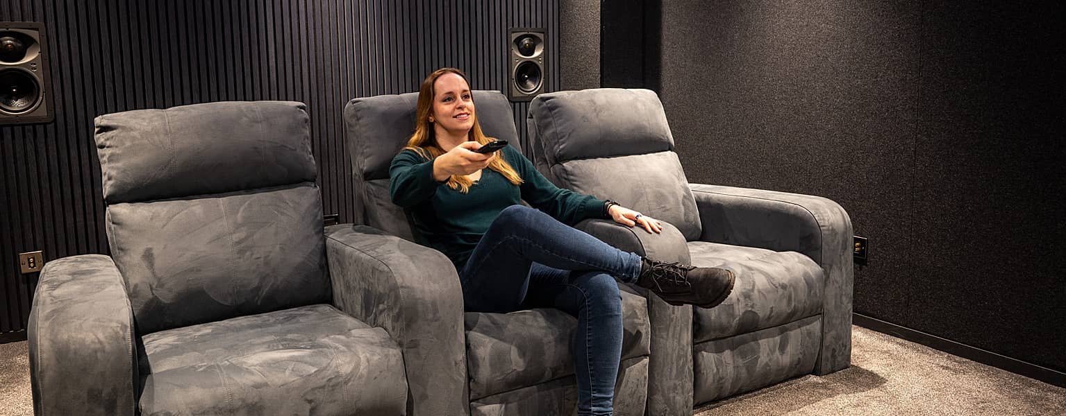 Person sitting on cinema seating in a Richer Sounds Experience Room