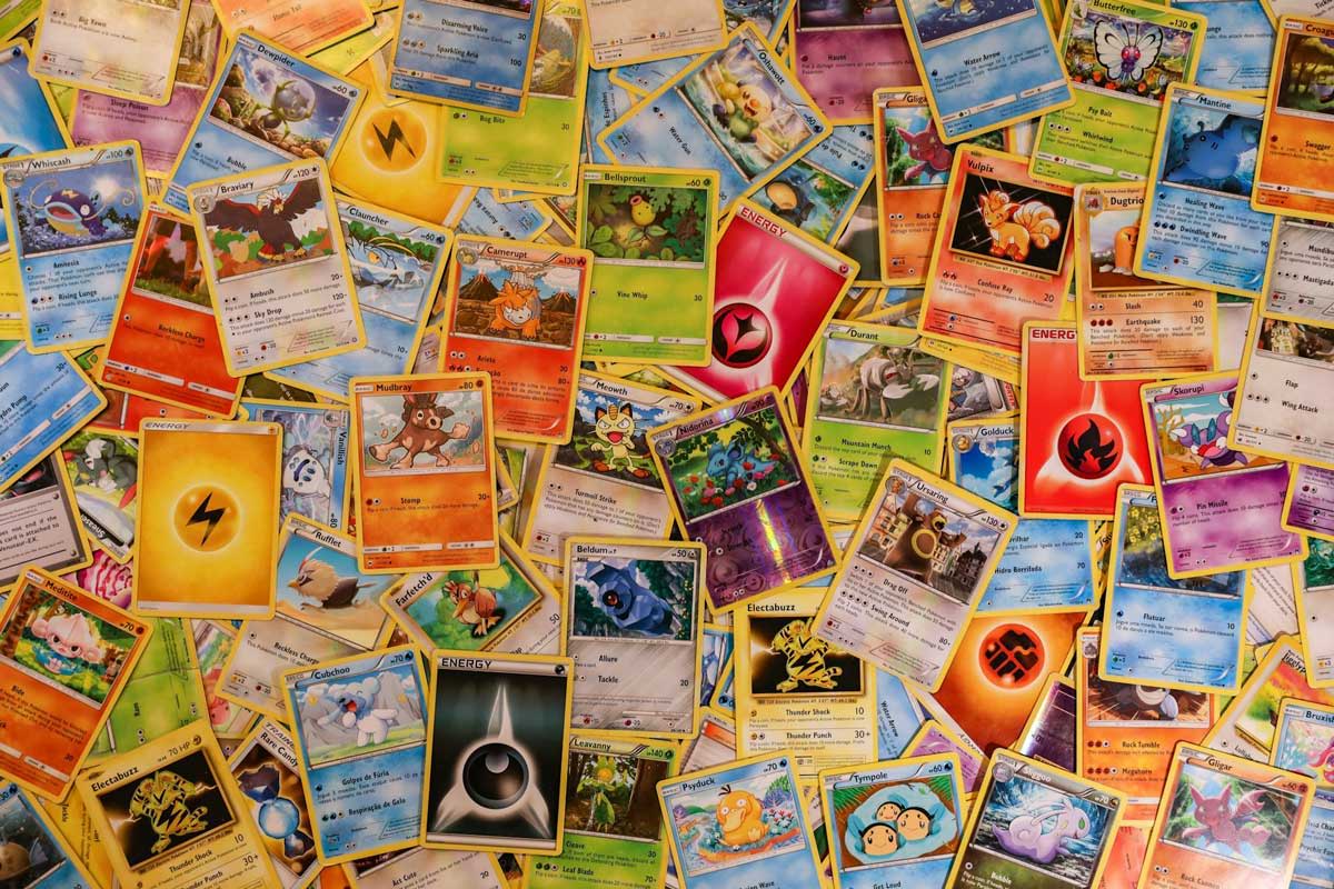 A collection of colorful trading cards scattered across a surface.