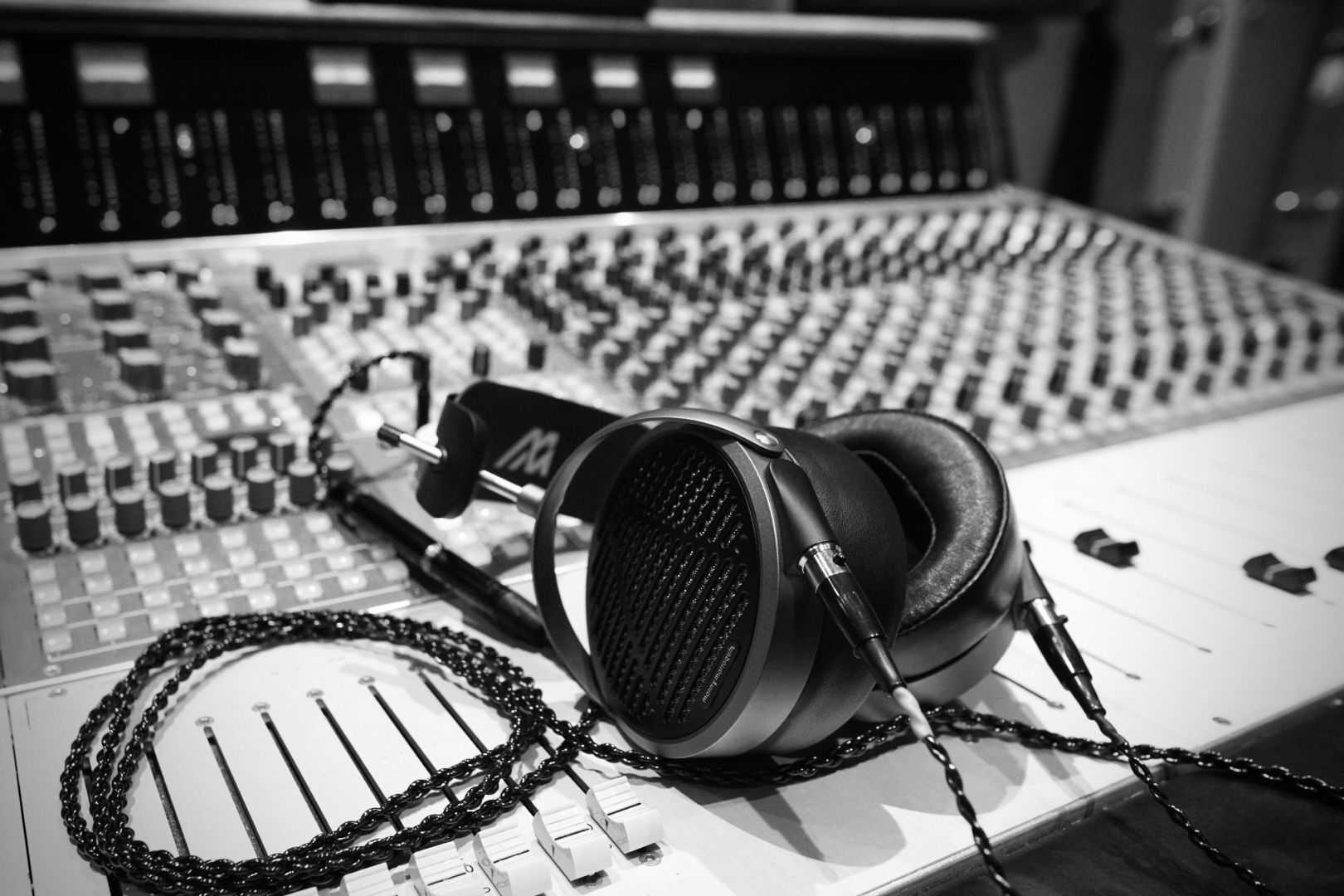 Audeze MM-500 headphones laying on mixing console in the studio 