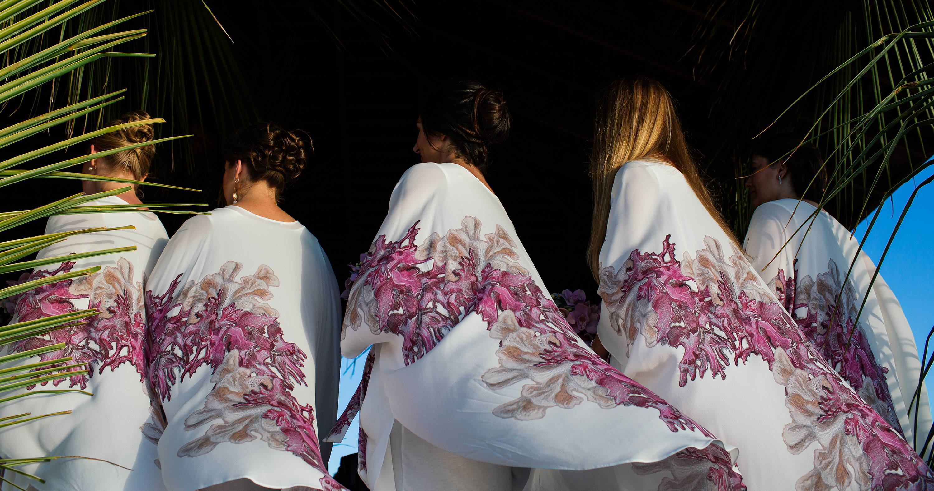 Woman wearing coral printed silk bridesmaid dresses by Ala von Auersperg