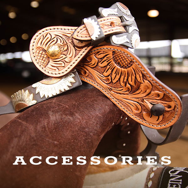 Close-up of ornate leather accessories for horseback riding.