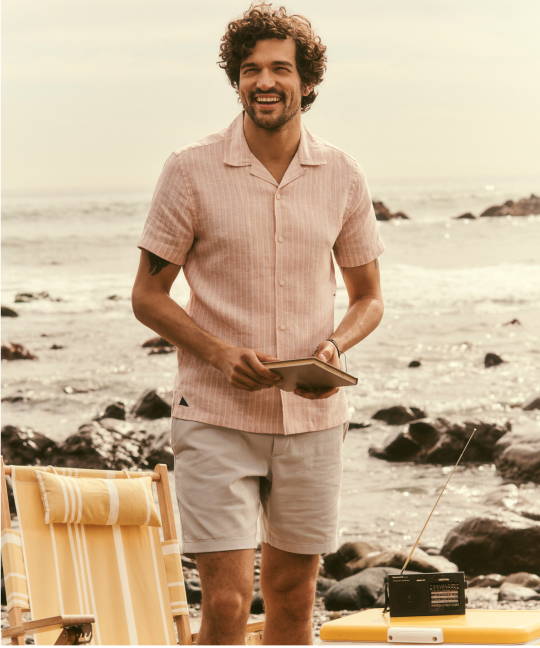 Model is wearing UNTUCKit Lenora buttondown with Whitley Drawstring shorts. 