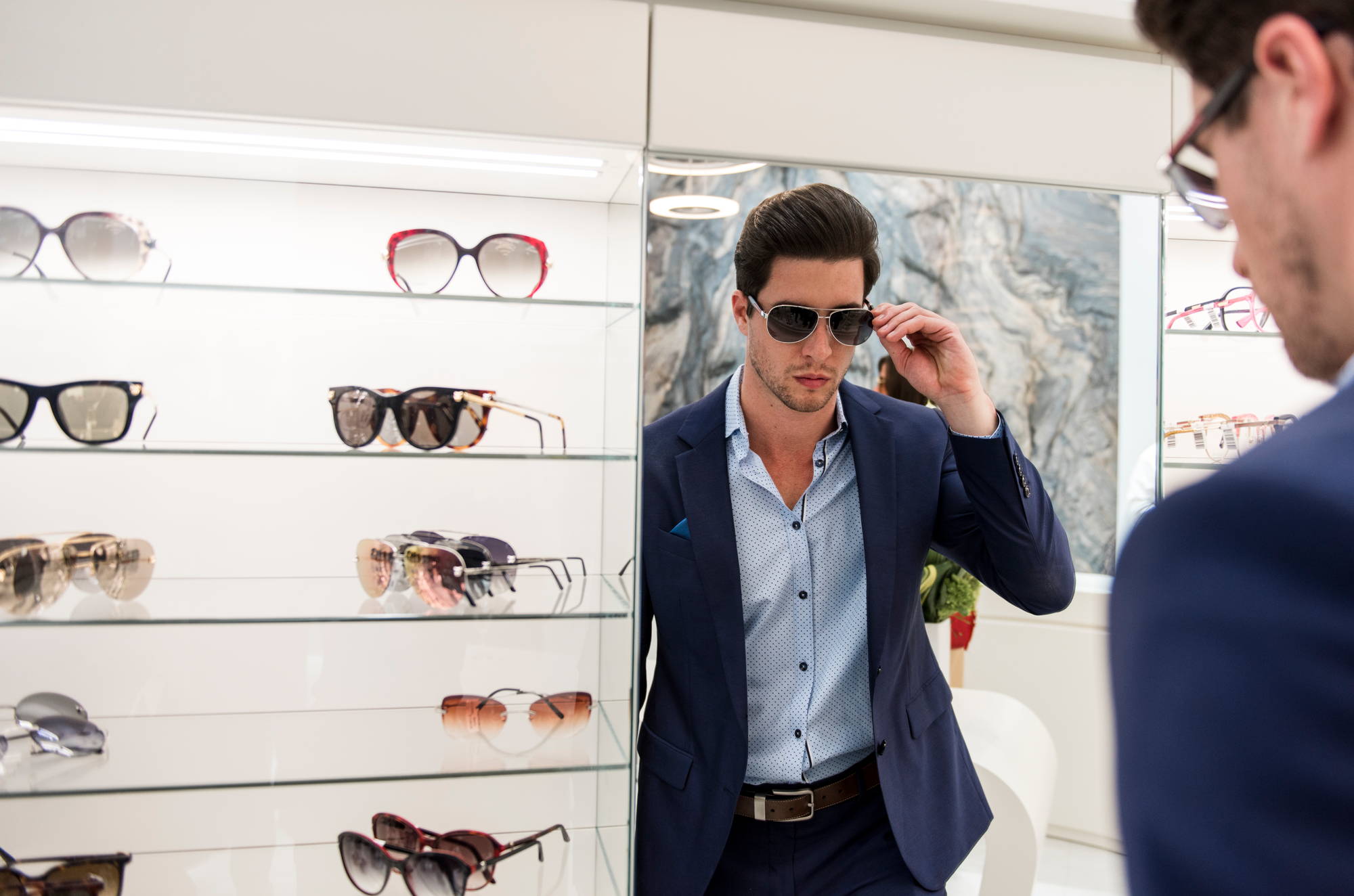 A man tries on sunglasses at Designer Eyes in Aventura Mall