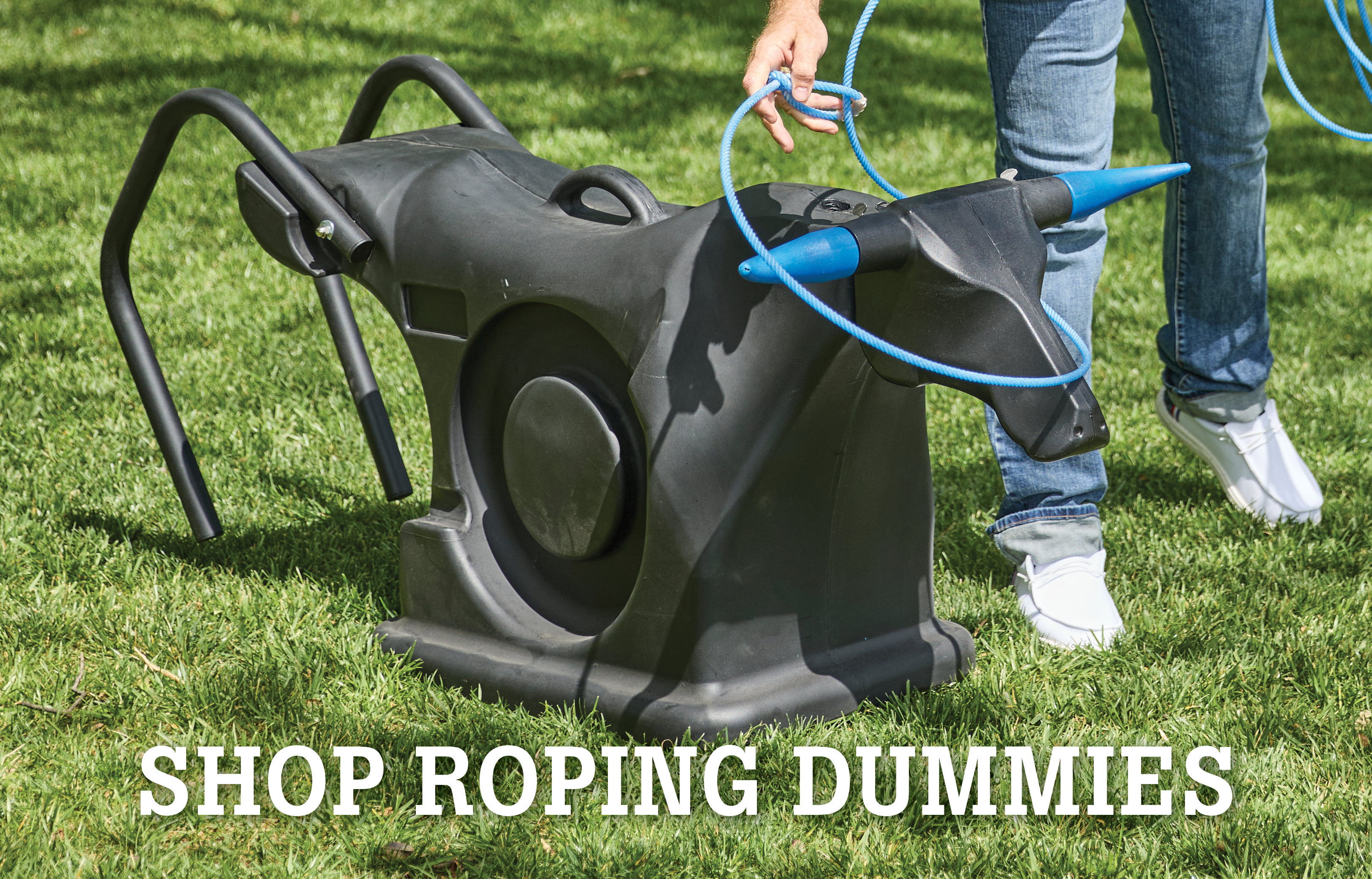 Roping dummy on grass with person preparing to rope it.