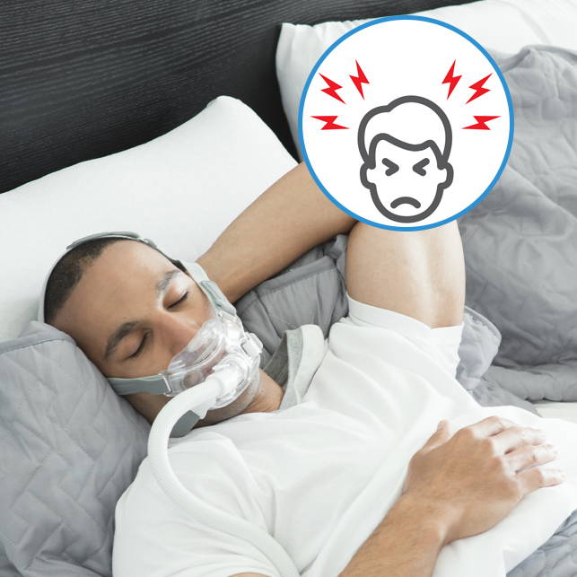 Man sleeping with a CPAP mask, showing signs of discomfort.