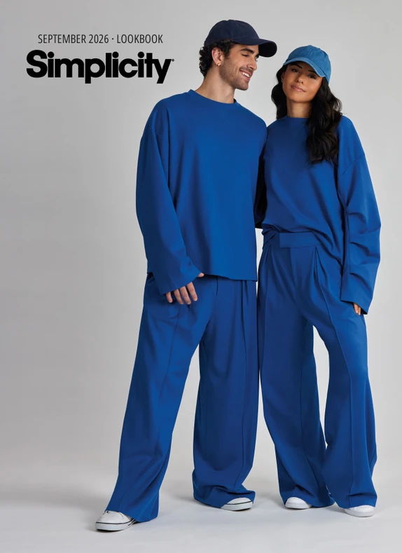 Two models wearing blue oversized outfits, standing side by side, with 