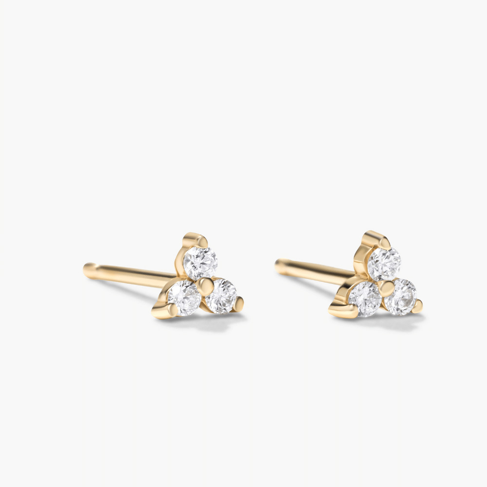 pair of earrings with three clustered diamonds on each earring in yellow gold