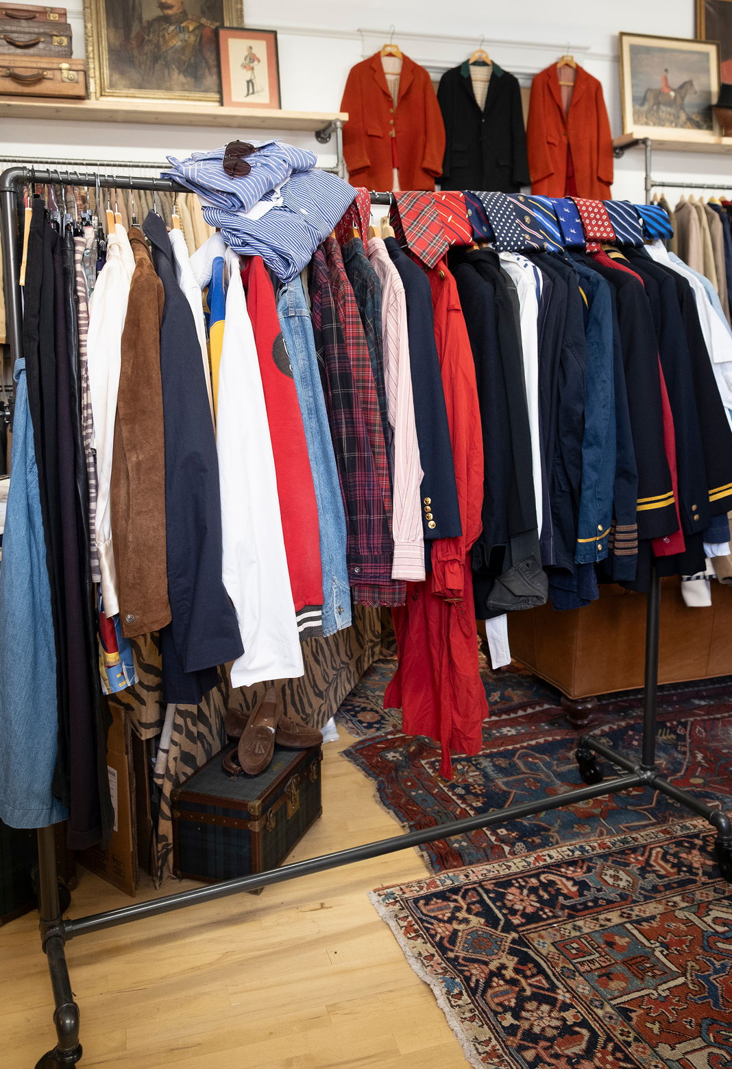 A rack of assorted clothing items in a vintage shop.