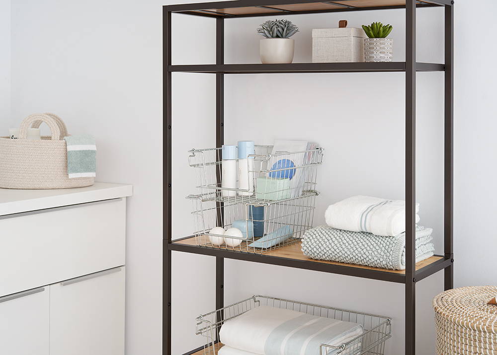 Stackable wire baskets on a shelf in bathroom with items inside