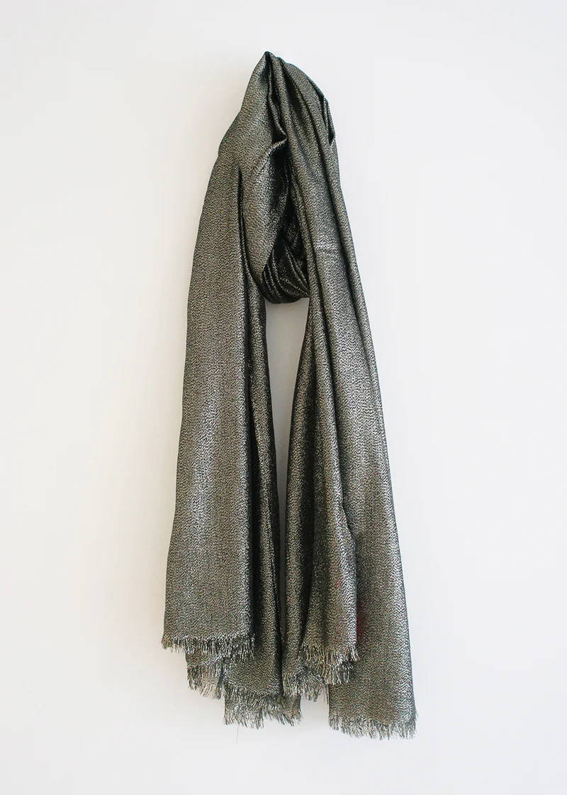 A black and gold sparkly scarf with raw hem detailling around the edge