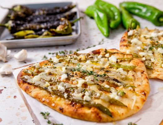 Flatbreads topped with cheese and green peppers, served with roasted peppers.
