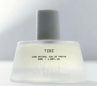 A clear perfume bottle labeled 
