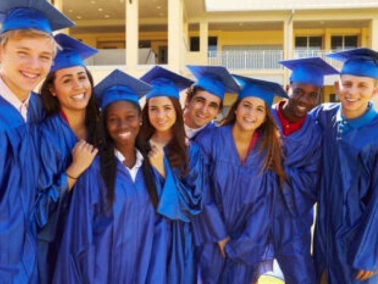 Group of students wearing blue graduation gowns