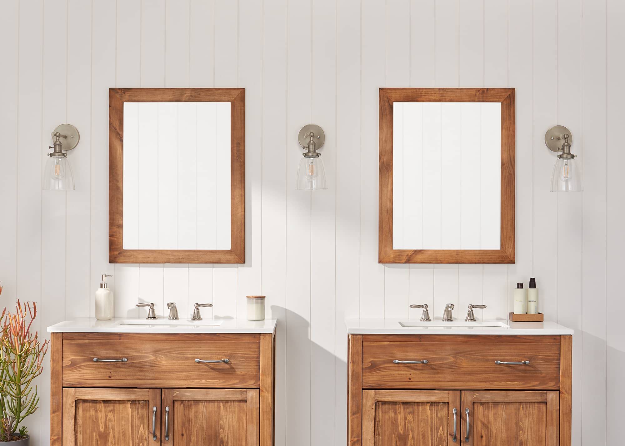 two farmhouse style vanity mirror in a bathroom