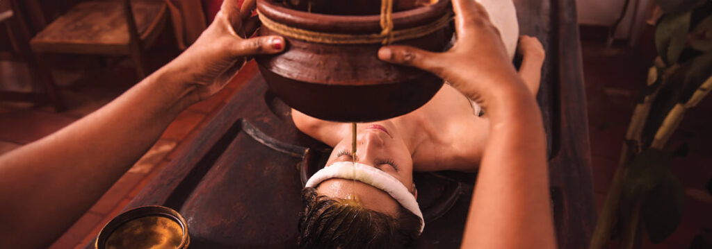 A person receiving an oil treatment in a wellness setting.