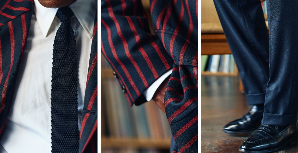 Close-up of a striped suit, shirt, tie, and polished shoes.