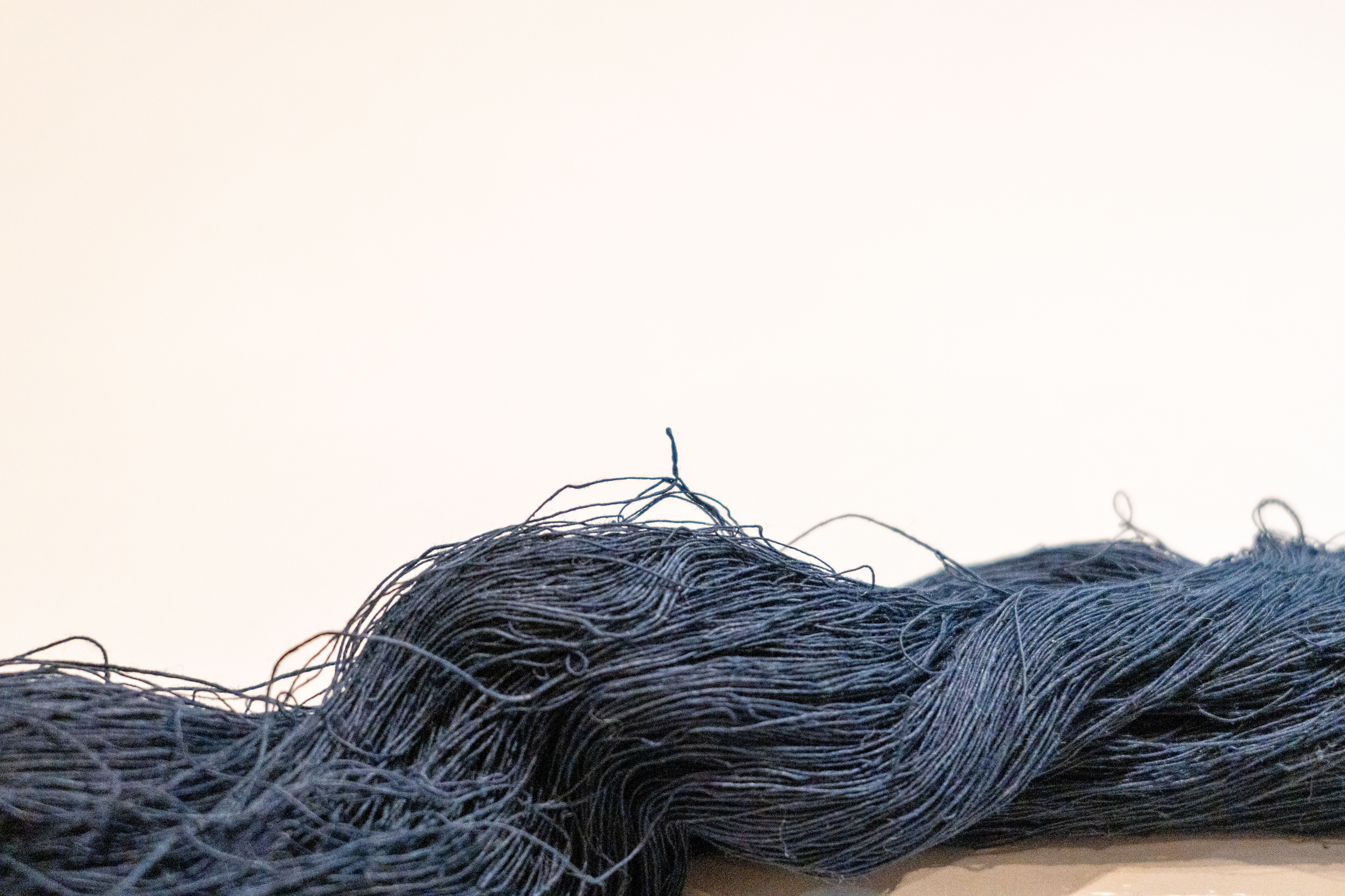 A bundle of blue yarn against a light background.