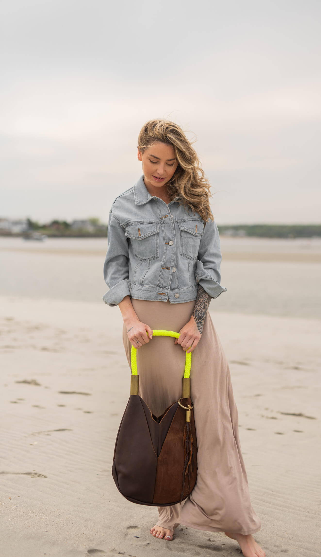 woman holding brown leather bag with neon yellow dock line