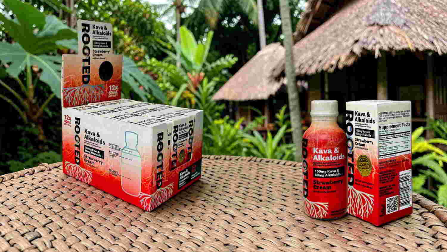 Two beverage packages on a table surrounded by greenery and thatched structures.